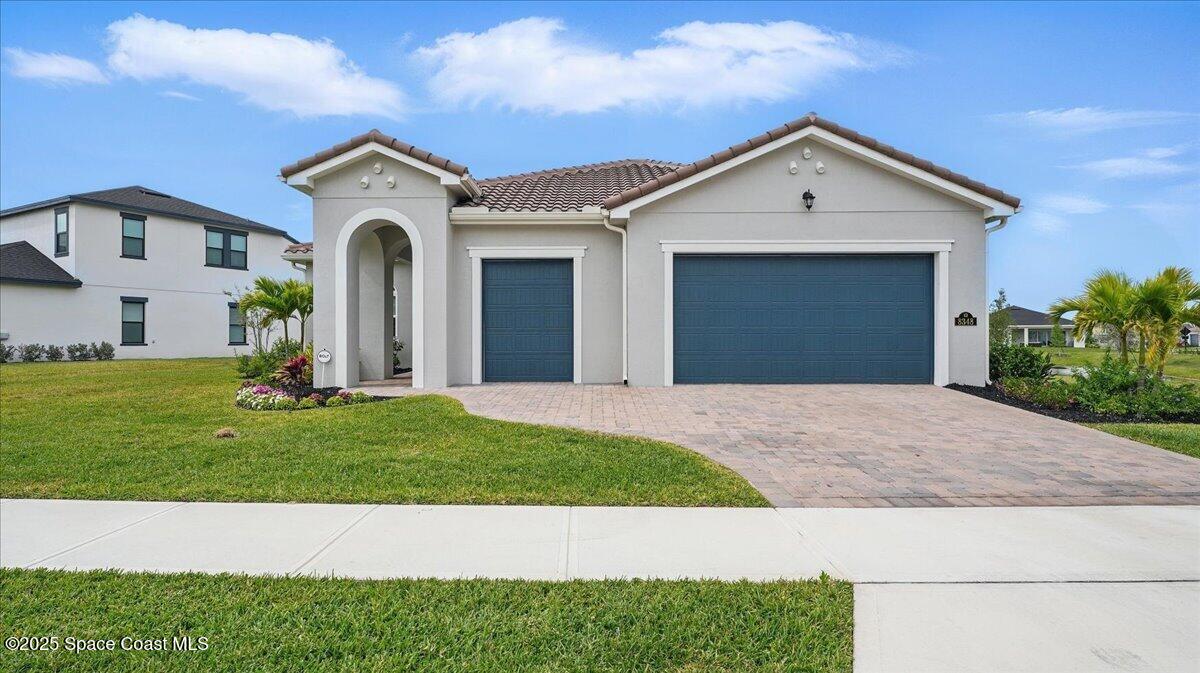8348 Gullen Drive Melbourne, FL 32940 - Photo 3 of 58 a front view of a house with a yard