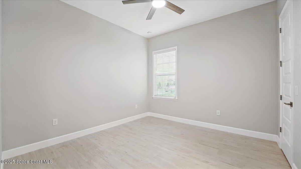8348 Gullen Drive Melbourne, FL 32940 - Photo 36 of 58 an empty room with a window and a fan