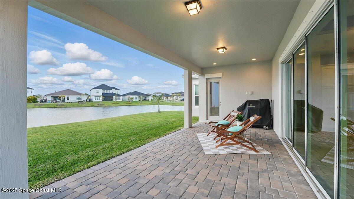 8348 Gullen Drive Melbourne, FL 32940 - Photo 37 of 58 a view of a balcony with chair and wooden floor
