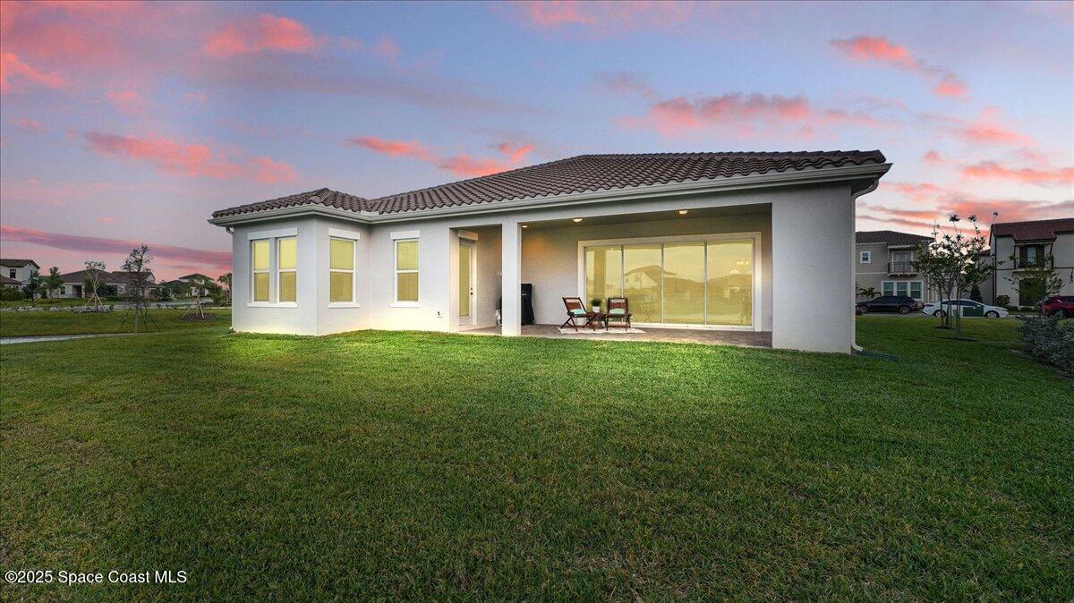 8348 Gullen Drive Melbourne, FL 32940 - Photo 39 of 58 a front view of a house with a garden and yard
