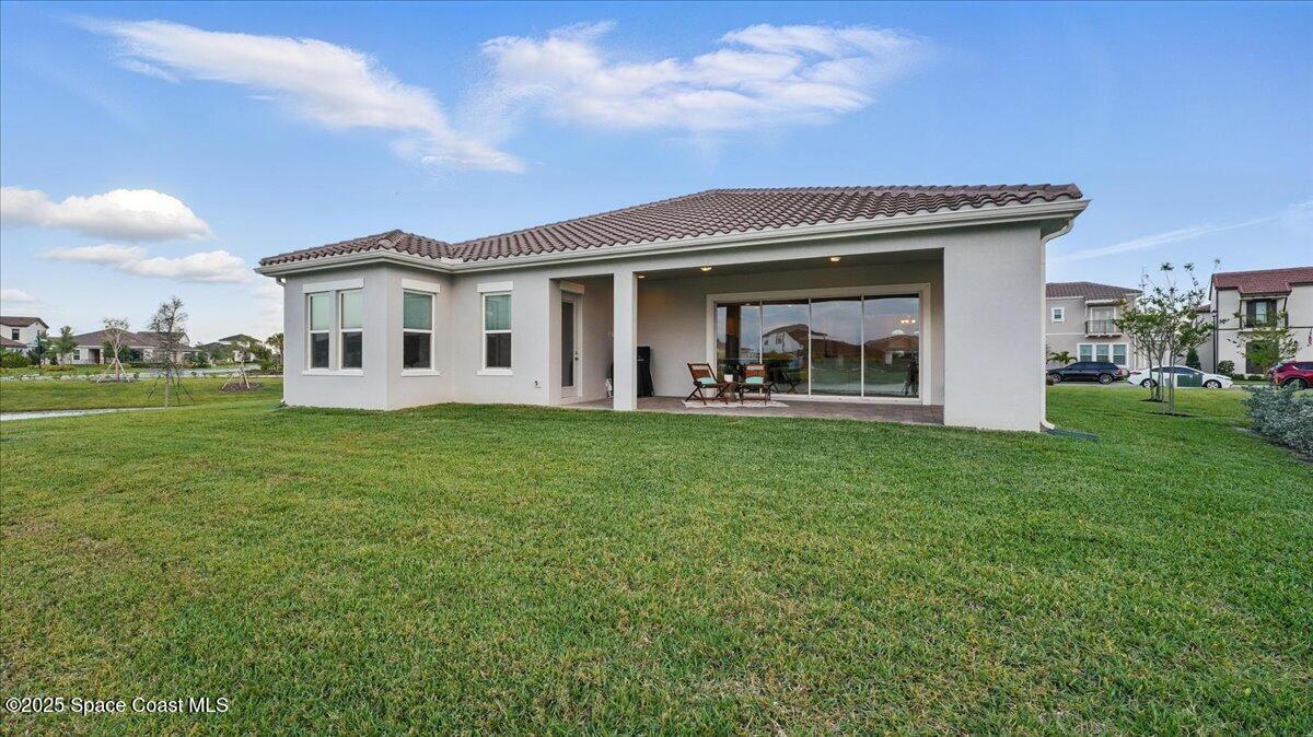 8348 Gullen Drive Melbourne, FL 32940 - Photo 40 of 58 a front view of a house with garden