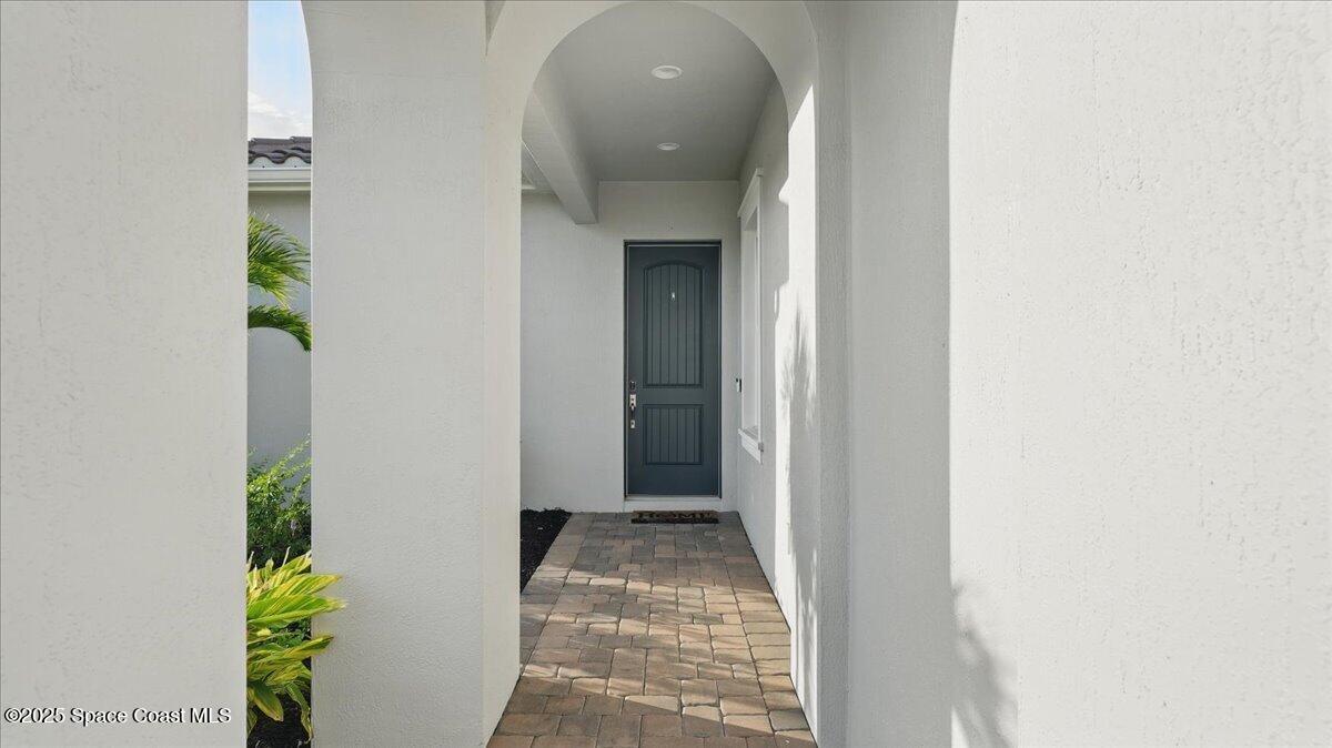 8348 Gullen Drive Melbourne, FL 32940 - Photo 7 of 58 a view of a hallway with wooden floor and a room