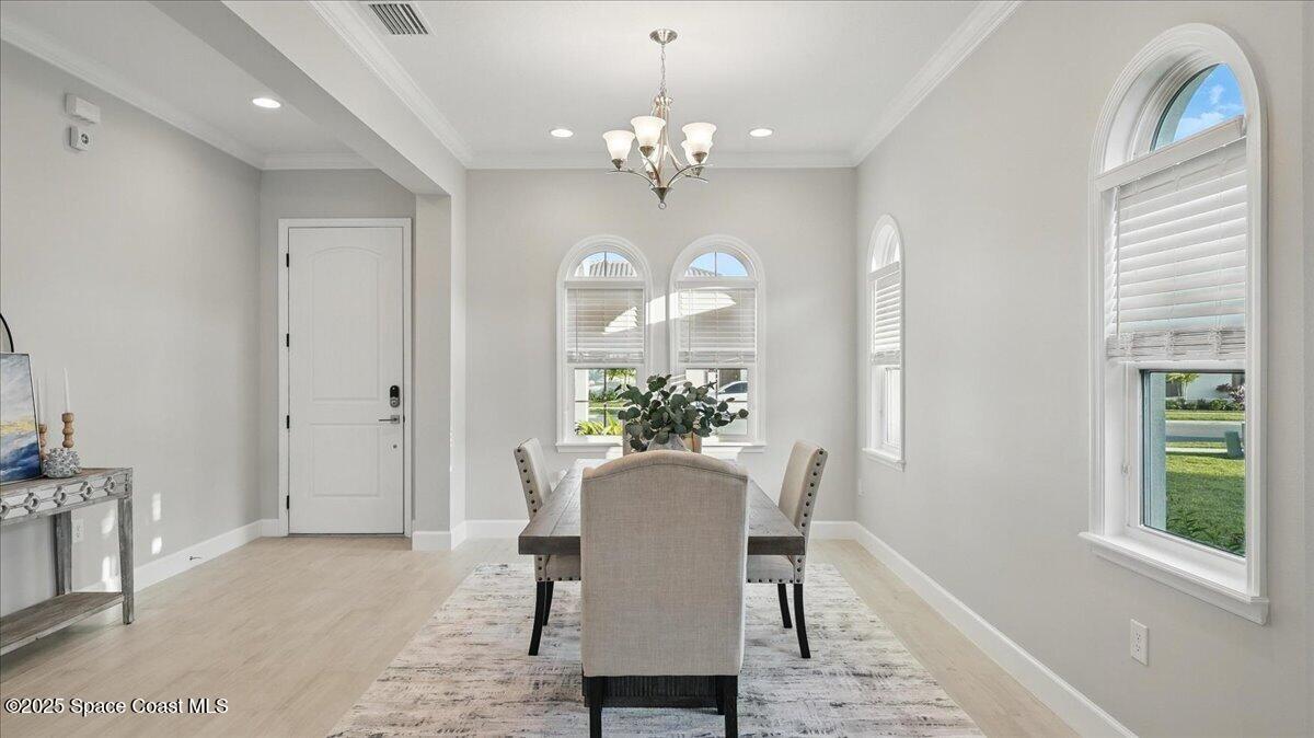 8348 Gullen Drive Melbourne, FL 32940 - Photo 9 of 58 a view of a dining room with furniture and a chandelier