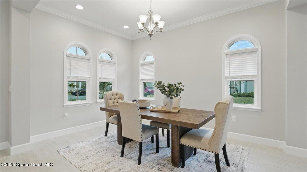 8348 Gullen Drive Melbourne, FL 32940 - Photo 10 of 58 a view of a dining room with furniture window and wooden floor