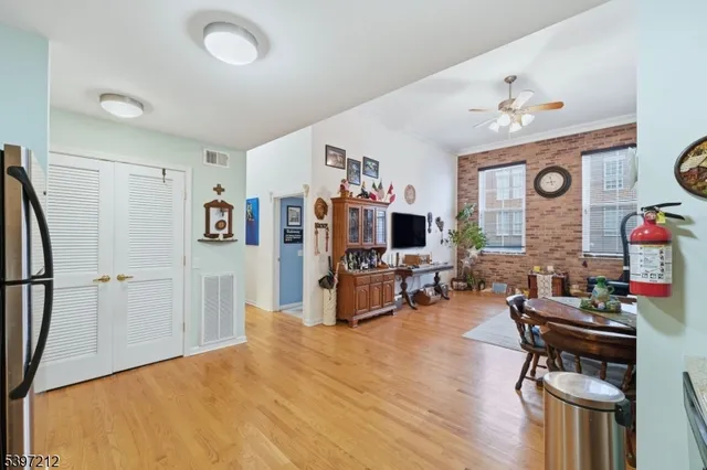 a living room with furniture a flat screen tv and a table