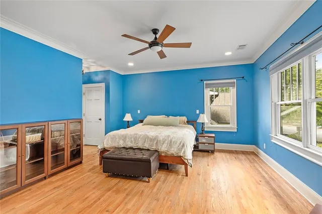a bed room with a bed and a ceiling fan