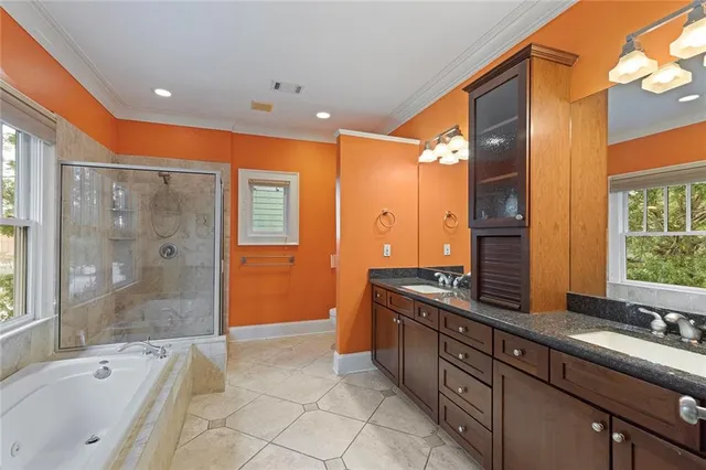 a bathroom with a tub a sink and a large window