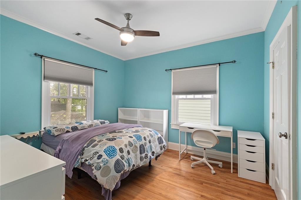 120 Park Place Decatur, GA 30030 - Photo 21 of 35 a bedroom with a bed and a dresser with wooden floor
