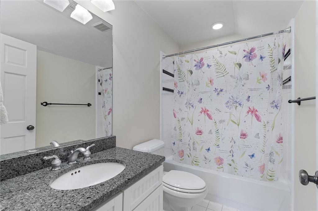 120 Park Place Decatur, GA 30030 - Photo 27 of 35 a bathroom with a sink toilet a shower curtain and a mirror
