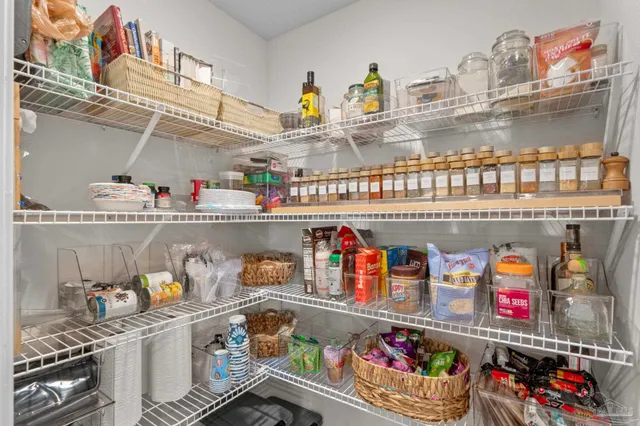 a store room with lots of clutter and cabinets