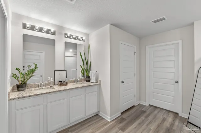 a bathroom with a double vanity sink and mirror