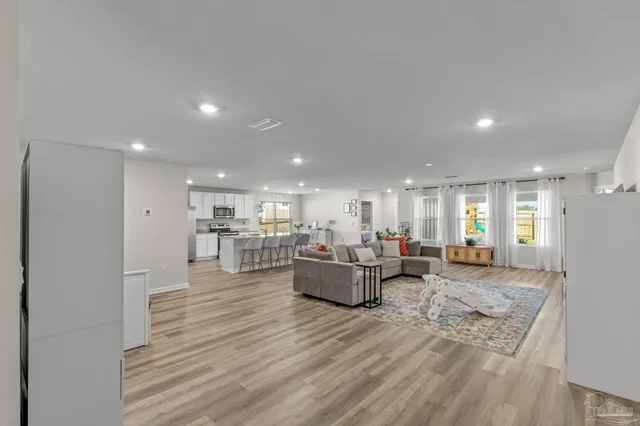 a living room with furniture and kitchen view