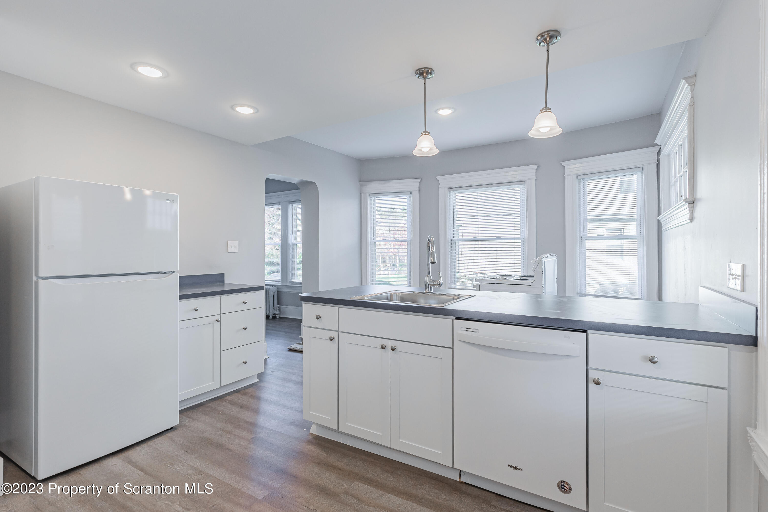 802 Quincy Avenue Scranton, PA 18510 - Photo 6 of 17 a kitchen with white cabinets and sink