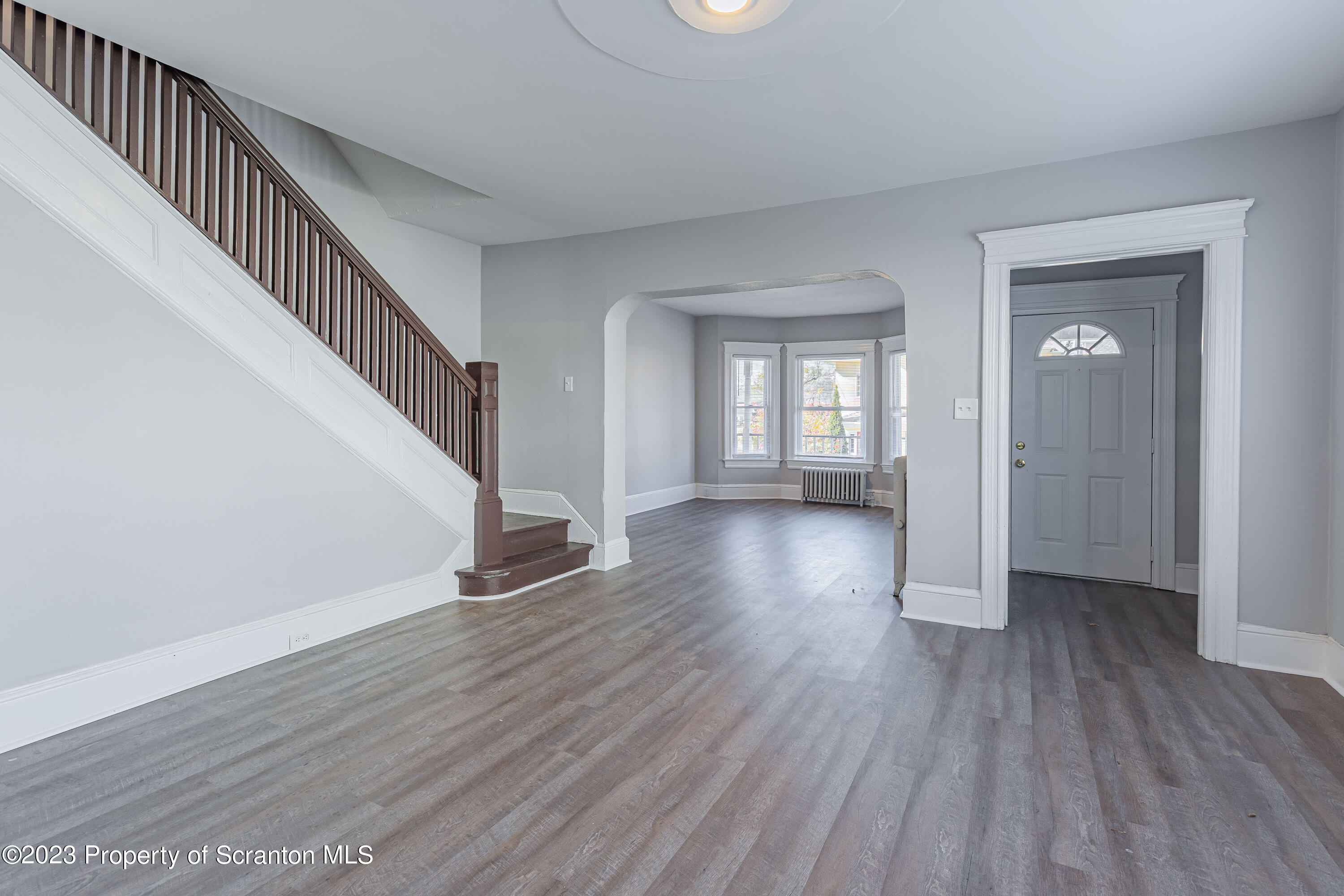 802 Quincy Avenue Scranton, PA 18510 - Photo 7 of 17 a view of empty room with wooden floor and fan