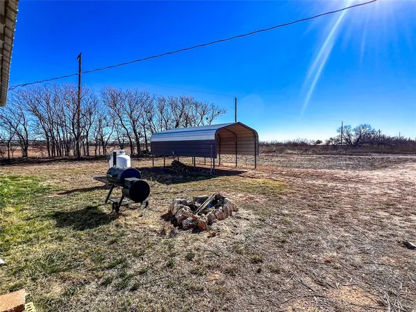 a view of a backyard with a table and chairs