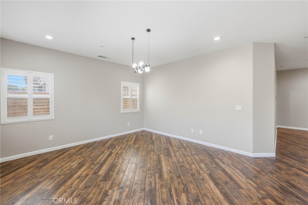 956 West Tibbot Street Rialto, CA 92377 - Photo 10 of 37 wooden floor in an empty room with a window