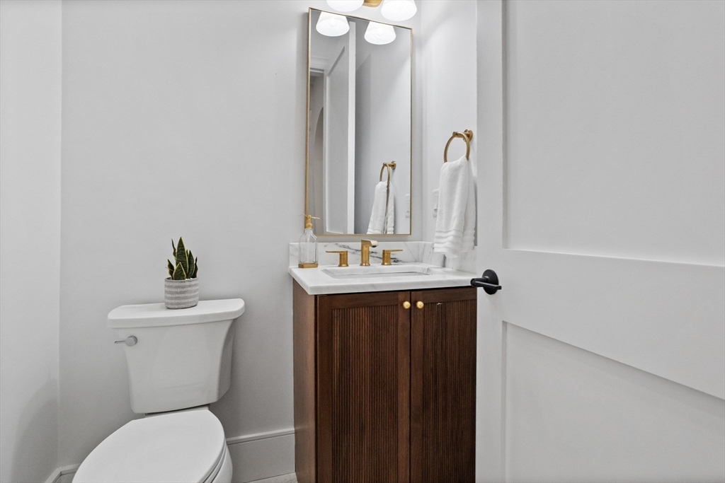 15 Peachtree Road Lexington, MA 02420 - Photo 27 of 42 a bathroom with a sink vanity mirror and toilet