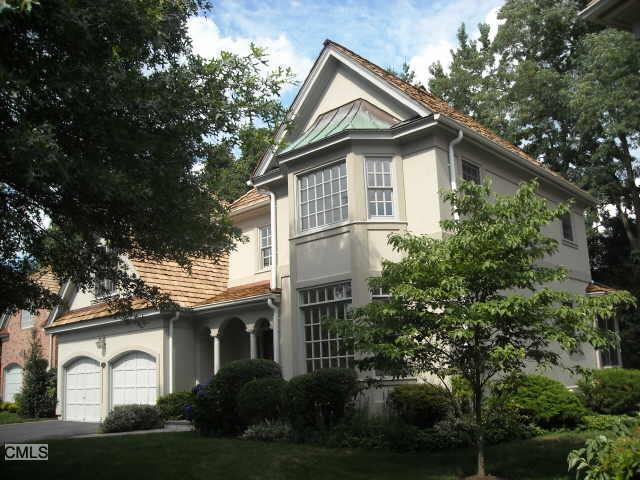 110 Stillson Road Fairfield, CT 06825 - Photo 1 of 1 a white house with a small yard plants and large trees
