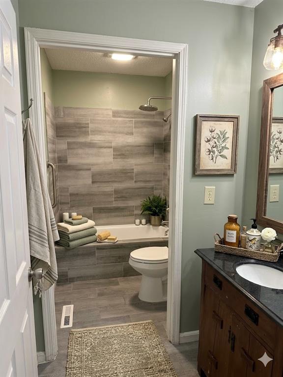 27 Carriage Trace Southeast Cartersville, GA 30121 - Photo 17 of 26 a bathroom with a granite countertop toilet a sink and a shower