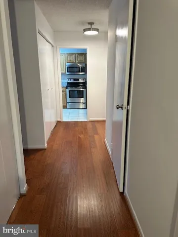 a view of a kitchen from a hallway