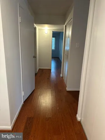 a view of hallway with wooden floor