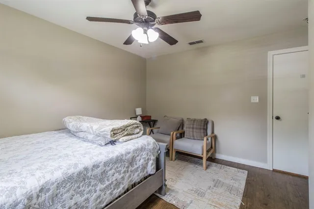 a bedroom with a bed and a ceiling fan