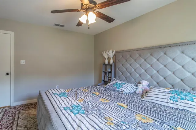 a bedroom with a bed and a chandelier