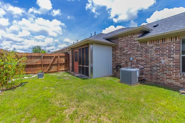 a view of a backyard with plants and a patio