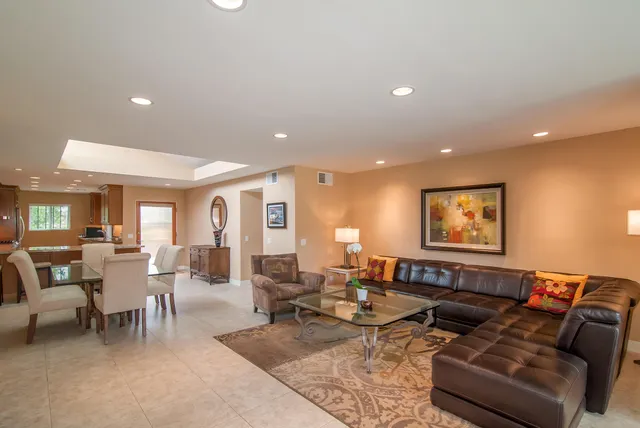 a living room with furniture and large window