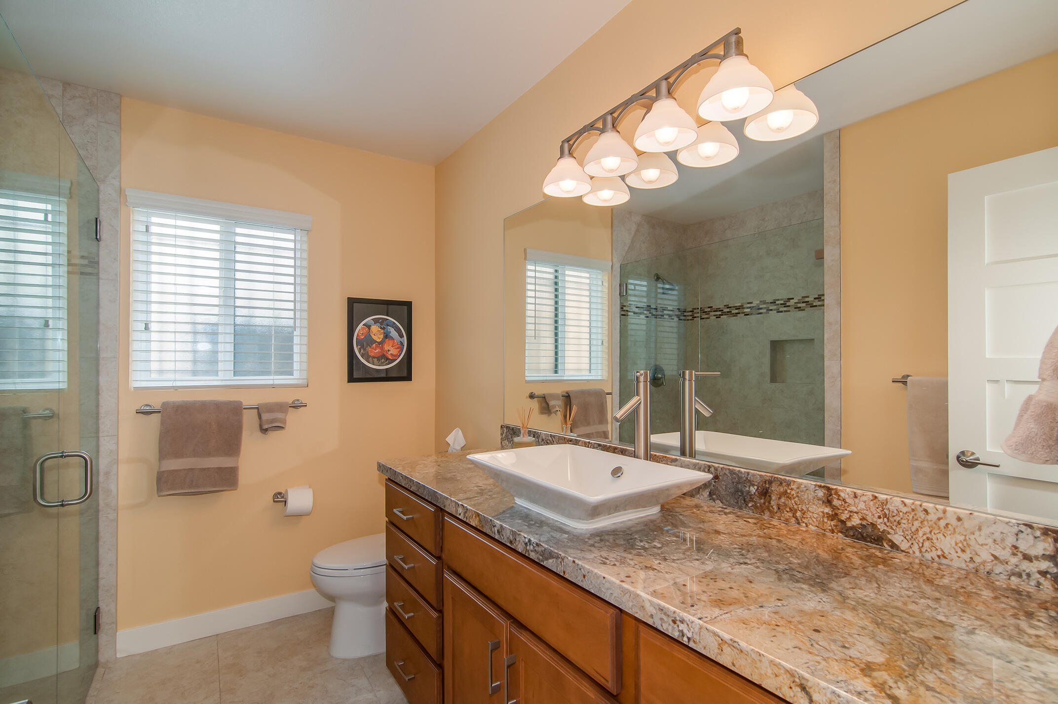 48275 Racquet Lane Palm Desert, CA 92260 - Photo 19 of 29 a bathroom with a granite countertop sink a toilet a mirror a vanity and window