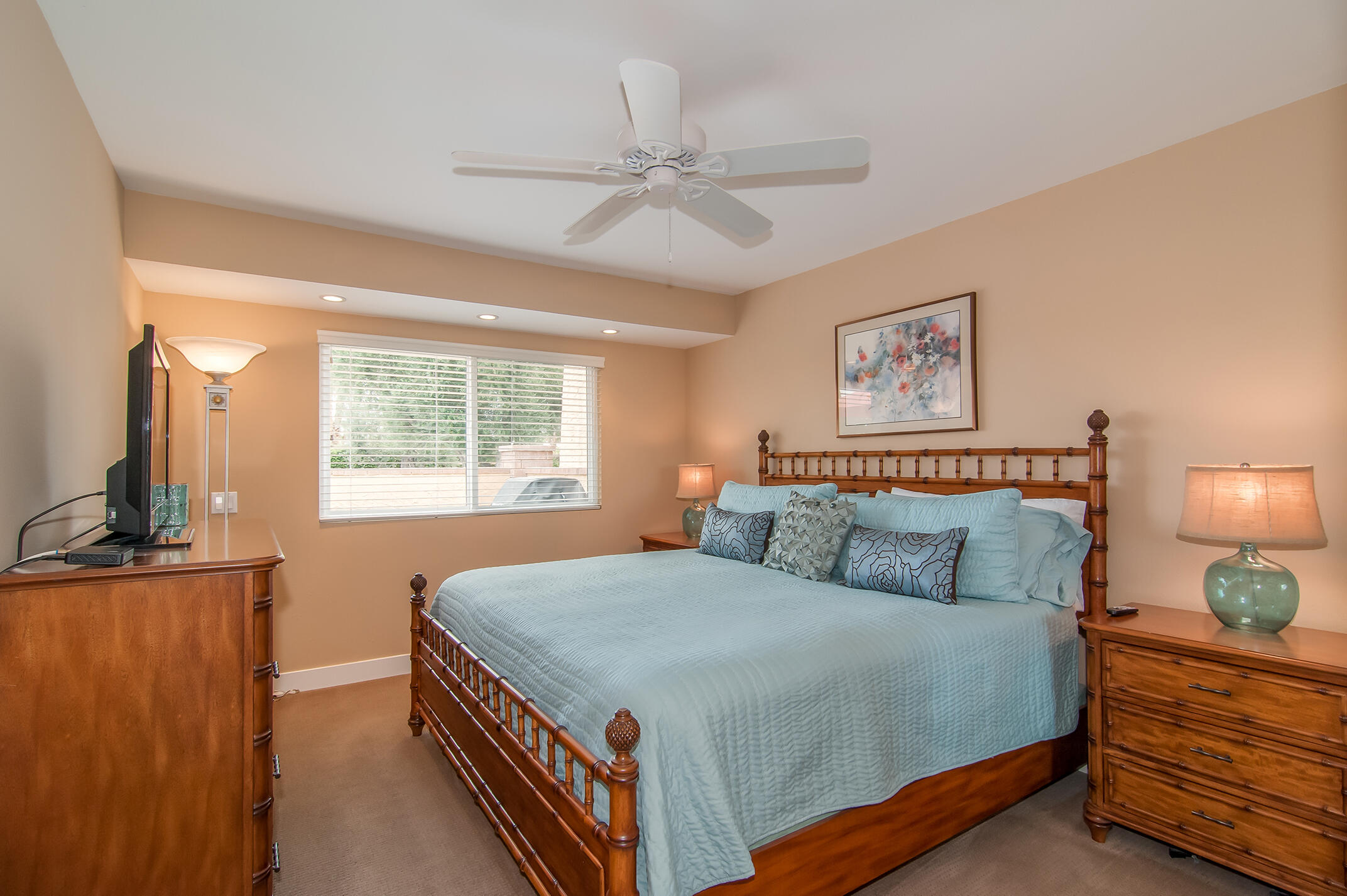 48275 Racquet Lane Palm Desert, CA 92260 - Photo 20 of 29 a bedroom with a bed and a flat tv screen on dresser