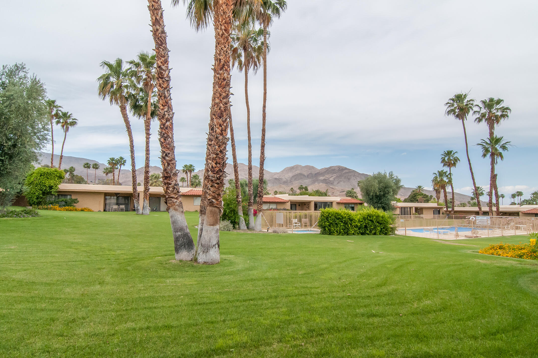 48275 Racquet Lane Palm Desert, CA 92260 - Photo 25 of 29 a house with palm trees in the background
