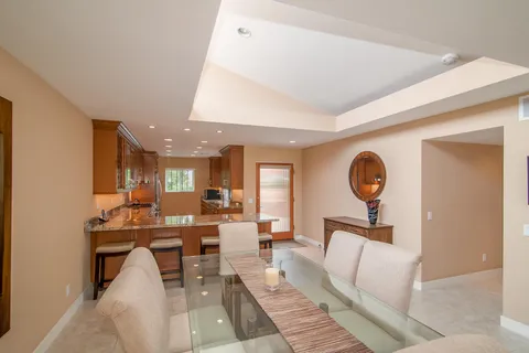 a living room with furniture a clock and a window