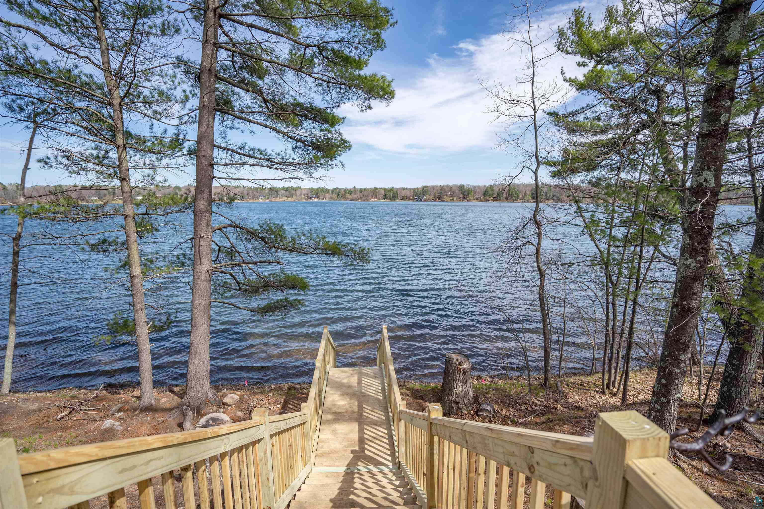2000 West Chub Lake Road Carlton, MN 55718 - Photo 5 of 30 Wood staircase descending to a natural waterfront with established trees