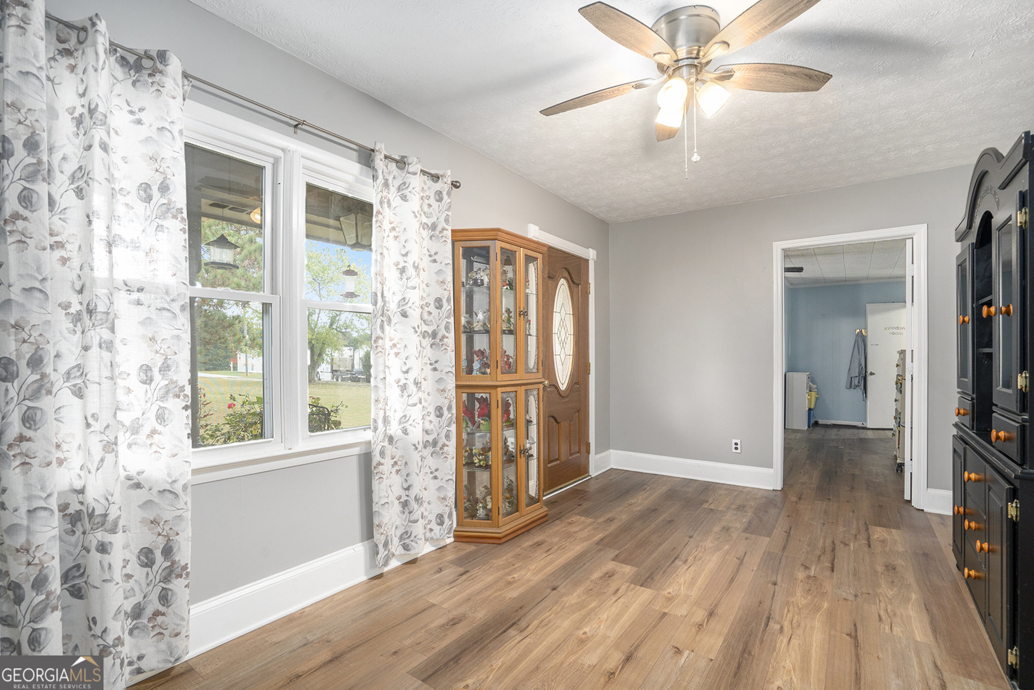1083 Hampton Road Hampton, GA 30228 - Photo 21 of 27 wooden floor in an empty room with a window