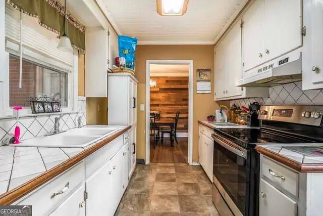 a kitchen that has a stove and a sink