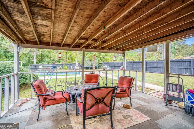 a view of a swimming pool with a couple of chairs