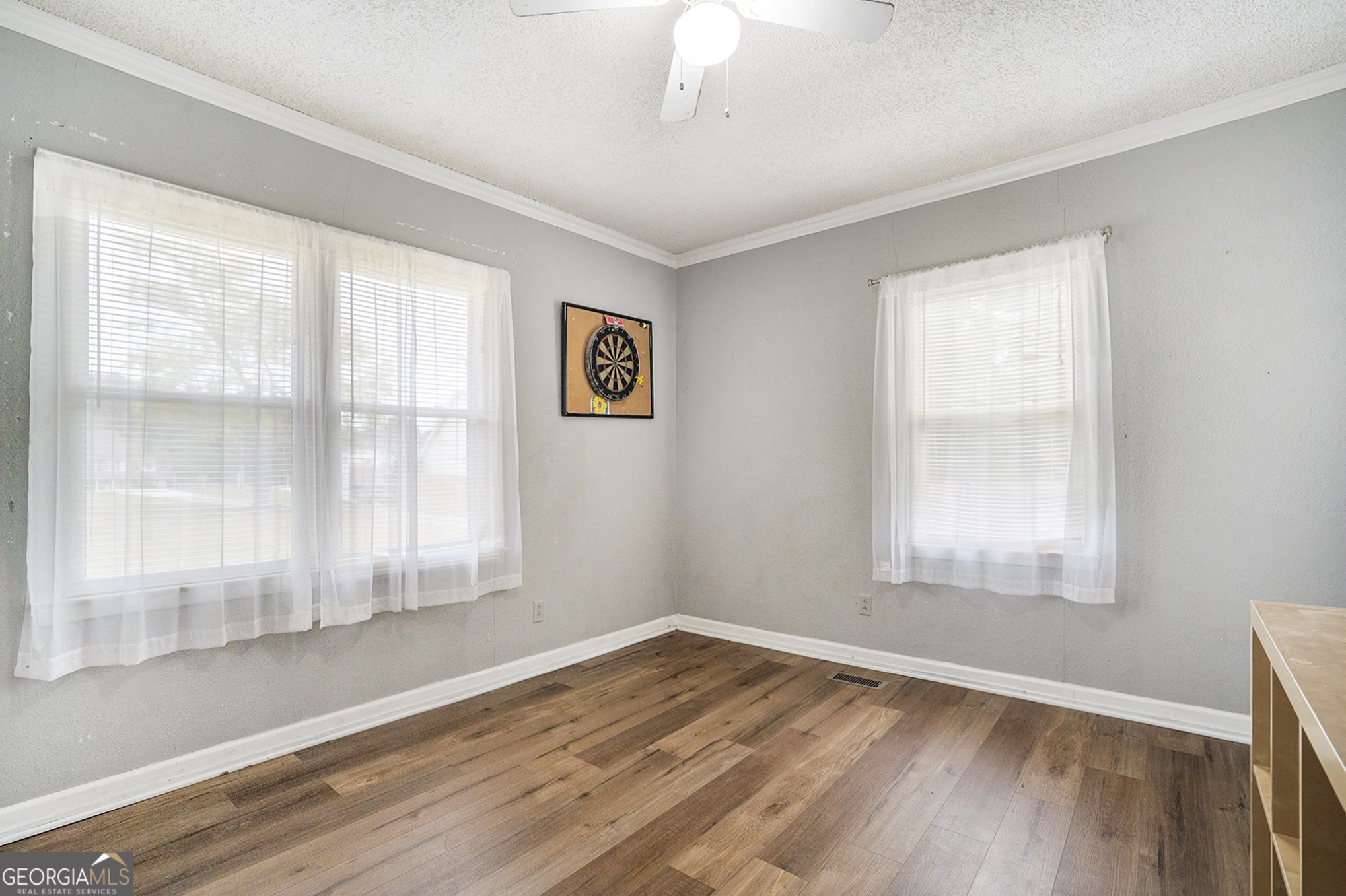1083 Hampton Road Hampton, GA 30228 - Photo 6 of 27 a view of an empty room with wooden floor and a window
