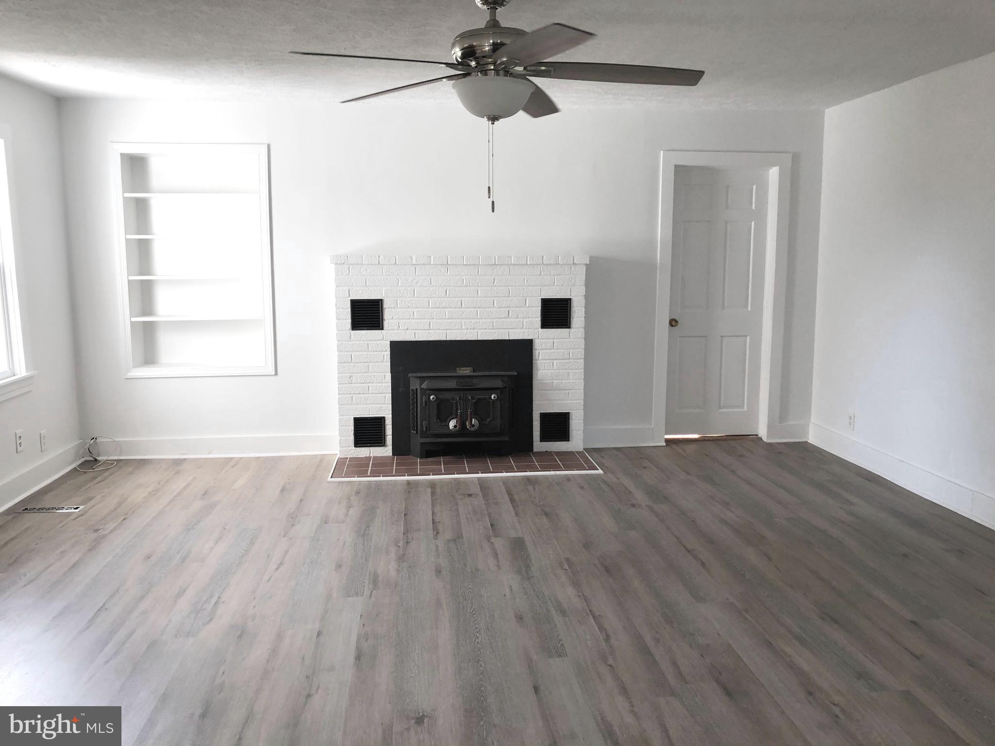 38150 Beach Road Coltons Point, MD 20626 - Photo 4 of 32 New flooring with brick fireplace