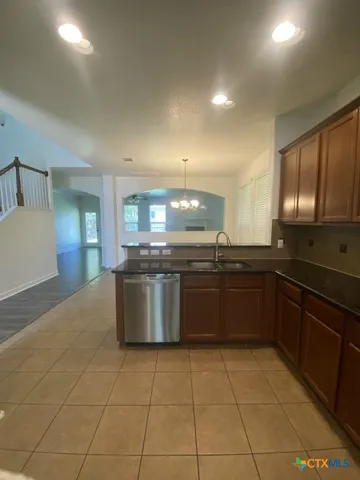 a large kitchen with a large counter top and appliances