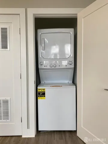 a kitchen with stainless steel appliances kitchen island granite countertop a stove a sink and a refrigerator