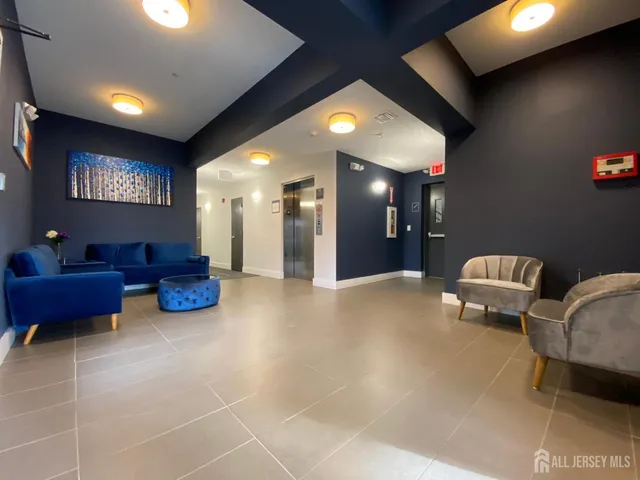 a lobby with furniture and a potted plant