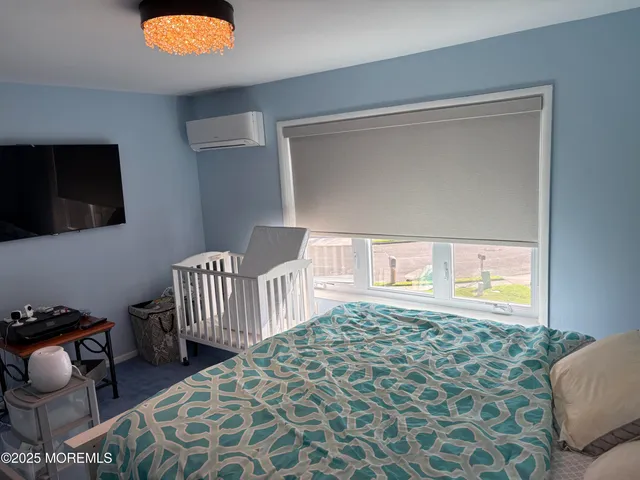 a bedroom with furniture and a window