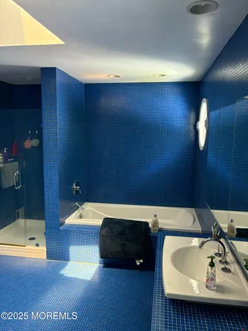 a bathroom with a tub and a sink