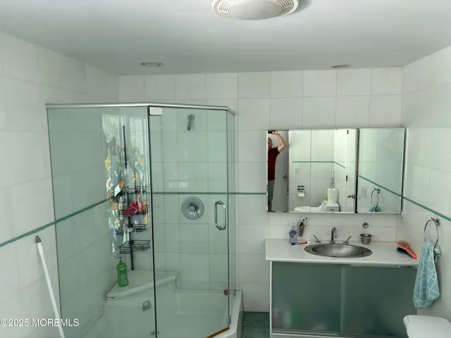 a bathroom with a sink and mirror with toilet