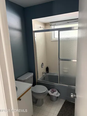 a bathroom with a toilet a sink and shower