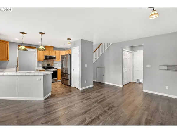 a view of a kitchen with wooden floor and a kitchen
