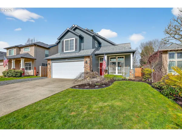 a front view of a house with a yard and garage