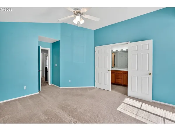 a view of a livingroom with a ceiling fan and entryway