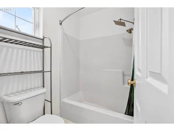 a bathroom with a shower a bath tub and a shower